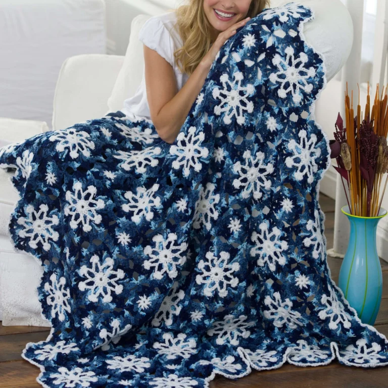 Dusty Snowflake Crochet Throw showcasing intricate patterns and cozy fabric